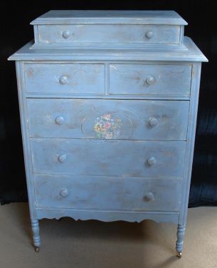 Pale blue country-style cabinet-top dresser on wheels; age uncertain..